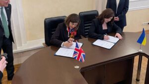 Sarah signing the Memorandum of Cooperation